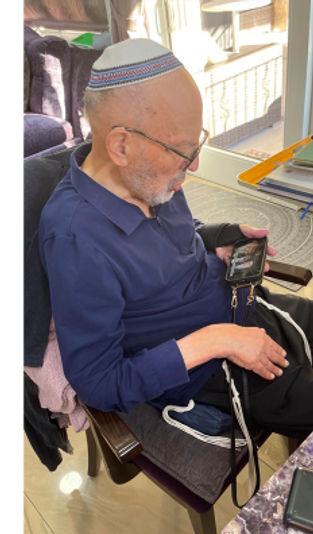 My dad enjoying a video on his phone