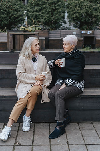 Two old women chatting with coffee
