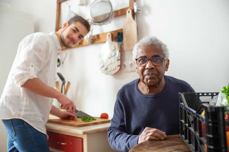 Old black man with younger caregiver